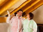 couple installing thermal insulation
