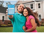 Man and woman, with the man holding the ENERGY STAR Certified Homes Label
