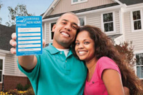 Couple in front of house holding ENERGY STAR label