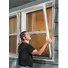 Man installing a storm window
